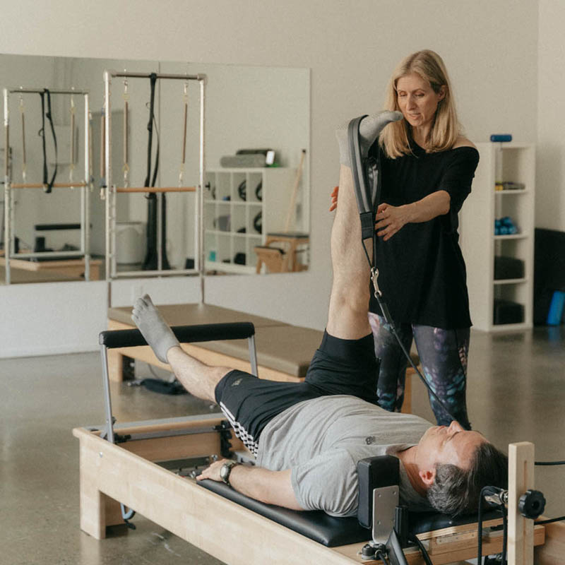 Pilates instructor is teaching a Private Pilates class